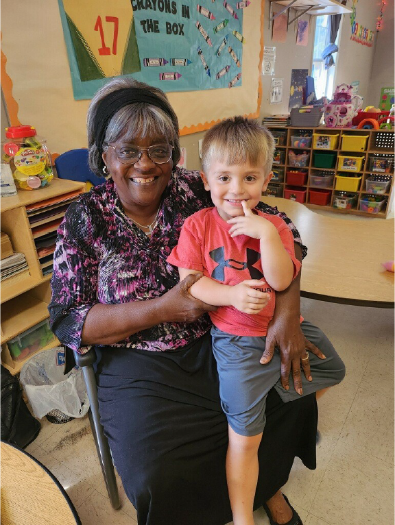 A Foster Grandparent pictured with a student