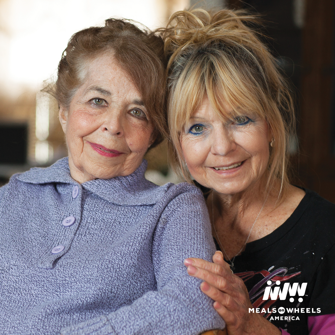 A Meals On Wheels client pictured with a volunteer